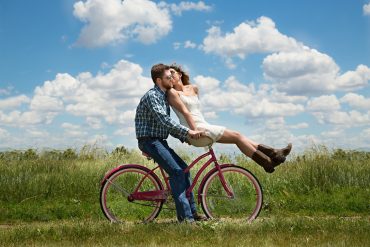 happy couple on a bike